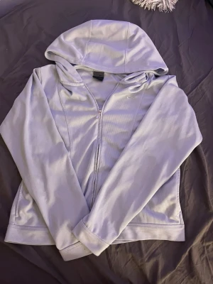 Snygg Ljusblå hoodie med dragkedja Nike - Använd lite grann men fortfarande i nytt skick👍. Den ser lite lila ut men den är ljusblå. Man kan använda den vardagligen och när man tränar. Tveka inte på att fråga om priset eller om fler bilder❤️