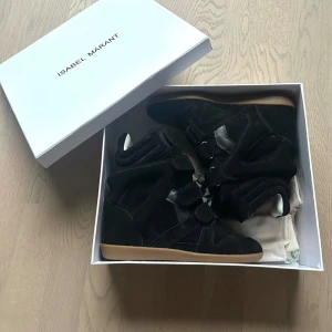 Isabel Marant svarta wedge sneakers - Säljer mina svarta isabel marant skor i mocka och skin som jag bärt 3 gånger, jättefina skor men passar verkligen inte min stil. Kommer med originalkartong.