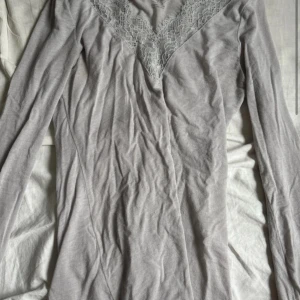 Ljusgrå spetsdetaljerad tröja Intimissimi - Supersnygg ljusgrå långärmad tröja från Intimissimi i ultralätt kashmirblandning. V-ringad med spetsdetaljer både vid halsringningen och vid ärmsluten som ger en extra lyxig känsla. Perfekt för lager-på-lager eller som statement-piece. Bilderna är från min vinted: linneal52