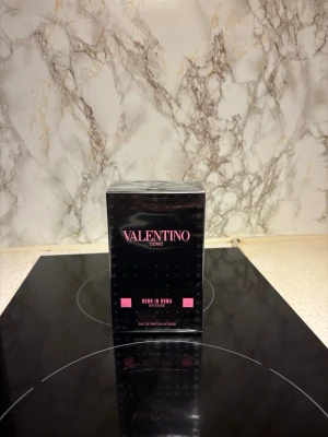 Valentino Uomo Born In Roma Intense - Säljer en lyxig parfym, Valentino Uomo Born In Roma Intense. Flaskan är svart med rosa detaljer och kommer i en elegant, fyrkantig kartong. Eau de Parfum Intense, perfekt för dig som gillar exklusiva dofter och snygg design. Kvitto finns på parfymen från kicks. 