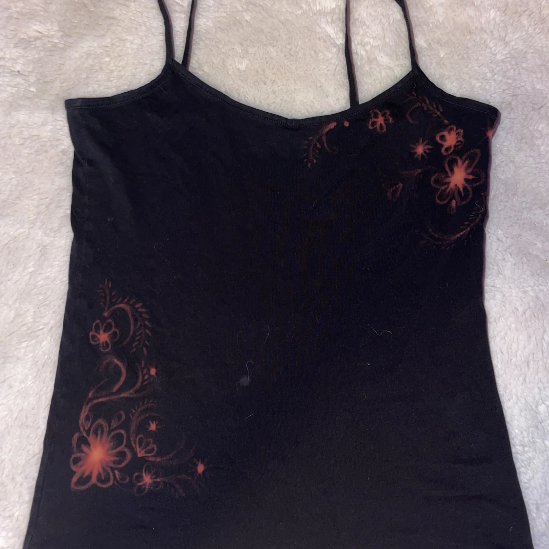 Svart linnetopp med blommigt mönster