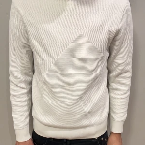 Vit tröja från Zara - Säljer en vit tröja från Zara. Tröjan har en enkel design med långa ärmar och ribbade detaljer vid hals och ärmslut. Perfekt för en casual stil, tröjan har även fläckar! Vill bli av med den så pris är ej hugget i sten 🪨 😊