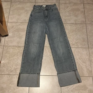 Vida jeans med uppvik från H&M - Snygga blå jeans från H&M i storlek 34 med breda och uppvikta ben. Använda fåtal gånger. 