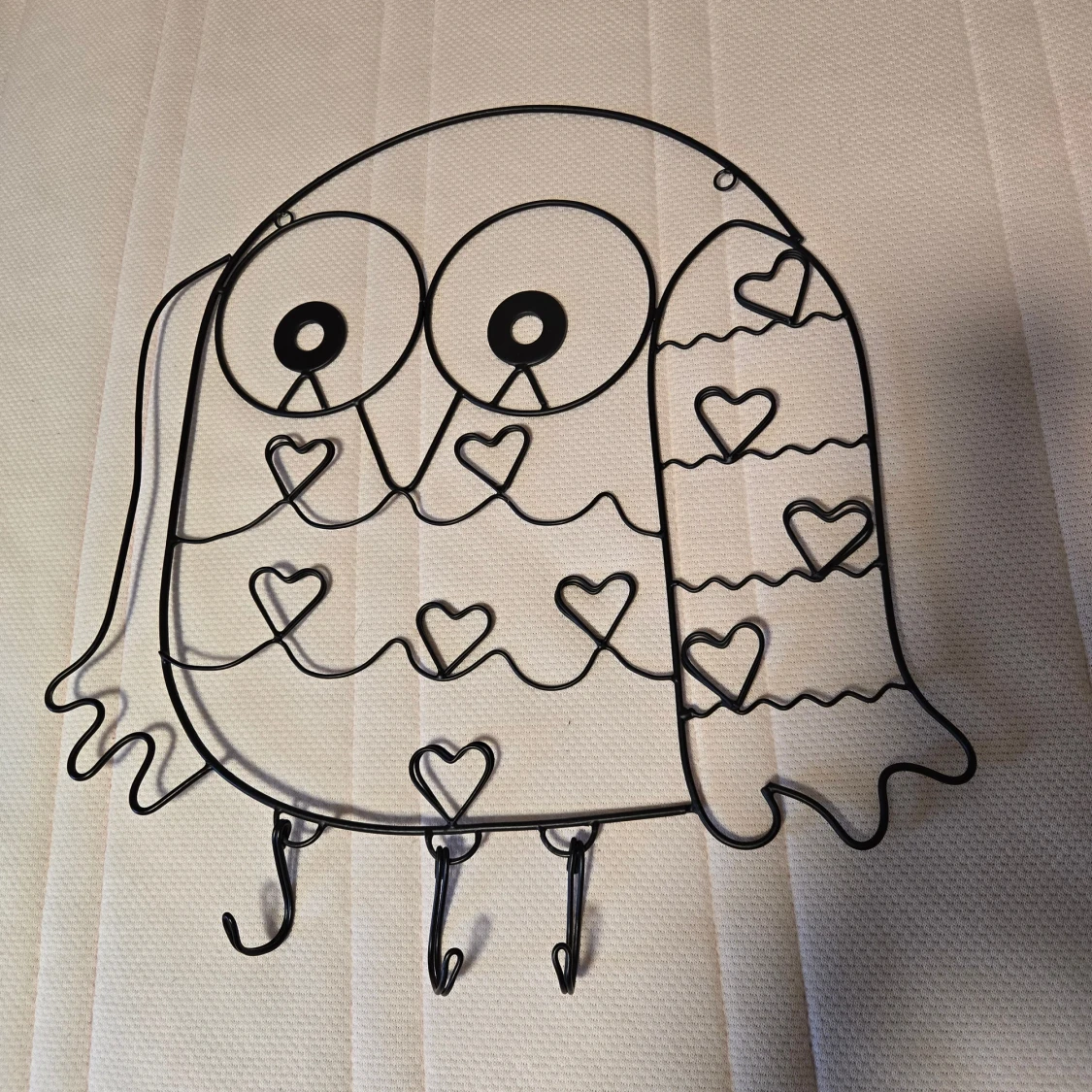 Svart uggleformad väggkrok i metall