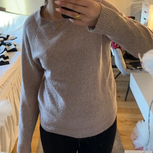 Beige stickad tröja - Mysig typ rosa stickad tröja med rund halsringning och långa ärmar. Perfekt för kyligare dagar och enkel att matcha med olika outfits. OBS! Den är lite nopprig 