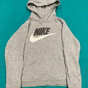 Grå hoodie från Nike - Säljer en grå hoodie från Nike för den är för liten och därför använder jag den inte så passar på att prova sälja den