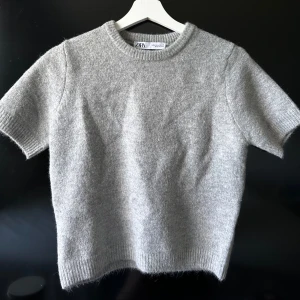 Grå stickad t-shirt - En grå stickad t-shirt ifrån Zara som är endast använd en gång. Går ej att köpa på hemsidan längre