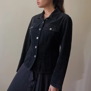 Vintage Corduroy Shirt Jacket - Vintage Black Cotton Corduroy Shirt worn to a perfectly soft feel. 100% Cotton. 6 Metal Embossed Buttons with "Authentic Jeans' Branding. Faux Frontal Pockets. Has some signs of wear- Minor Pinhole on back shoulder, overall Good Condition