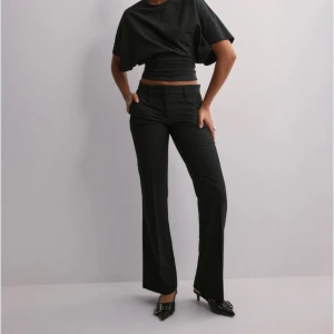 Svarta kostymbyxor från Nelly  - Lågmidjade flare kostymbyxor från Nelly i stl 40, väldigt fina på men blivit för små för mig. Inte använda särskilt mycket så bra skick. Skriv till mig om du har mer frågor!💗(artikelnr: 247706-0014)