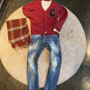Cardigan carhartt  - Säljer en snygg vinröd kofta från Carhartt i ull med en stor svart och vit bokstav 'C' på bröstet. Koftan har knappar framtill och långa ärmar. Perfekt för en stilren och avslappnad look. Strl M passar S bäst