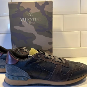 Valentino Rockrunners - Tja! Vi säljer återigen ett par snygga Valentino rockrunners med ett coolt camouflagemönster. Skorna har en kombination av olika material och färger som svart, grå och brun.