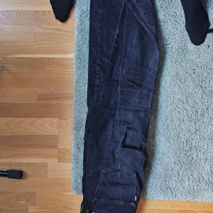 Svarta Levis 501 jeans - Säljer ett par klassiska svarta Levis 501 jeans. De har en rak passform och är tillverkade i bomull. Perfekta för en stilren look. 🖤