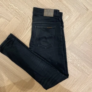 Svarta jeans från Nudie Jeans - Svarta jeans från Nudie Jeans med en slim passform. Modellen på bilden är 185cm lång. Kom gärna privat för exakta mått, fler bilder eller funderingar🤗