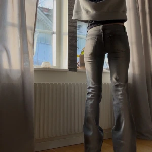 Grå jeans med bootcut - Snygga grå jeans med bootcut-stil som ger en avslappnad look. De är lågmidjade och har en klassisk femficksdesign. Perfekta för en casual outfit.