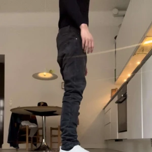 Gråa/svarta Nudie jeans - Sparsamt använda nudie jeans i 9/10 skick utan några defekter. Modellen på jeansen heter grim tim. Killen på bilden är 185cm och väger ca 70kg. Waist är 31och lenght är 34. Säljer pga att dem inte längre kommer till användning. 