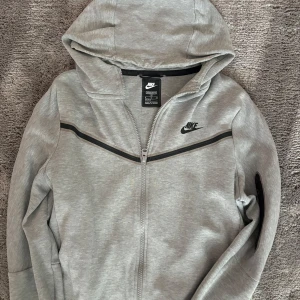 Grå nike tech - Säljer min sons gamla nike tech. Den är i bra skick och har inga synliga fläckar eller problem den har en bra passform!