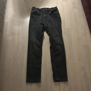 Svarta jeans från Jack & Jones - Snygga svarta jeans från Jack & Jones med klassisk femficksdesign. De har en rak passform och är perfekta för en stilren look. Passar till många olika tillfällen och outfits. 