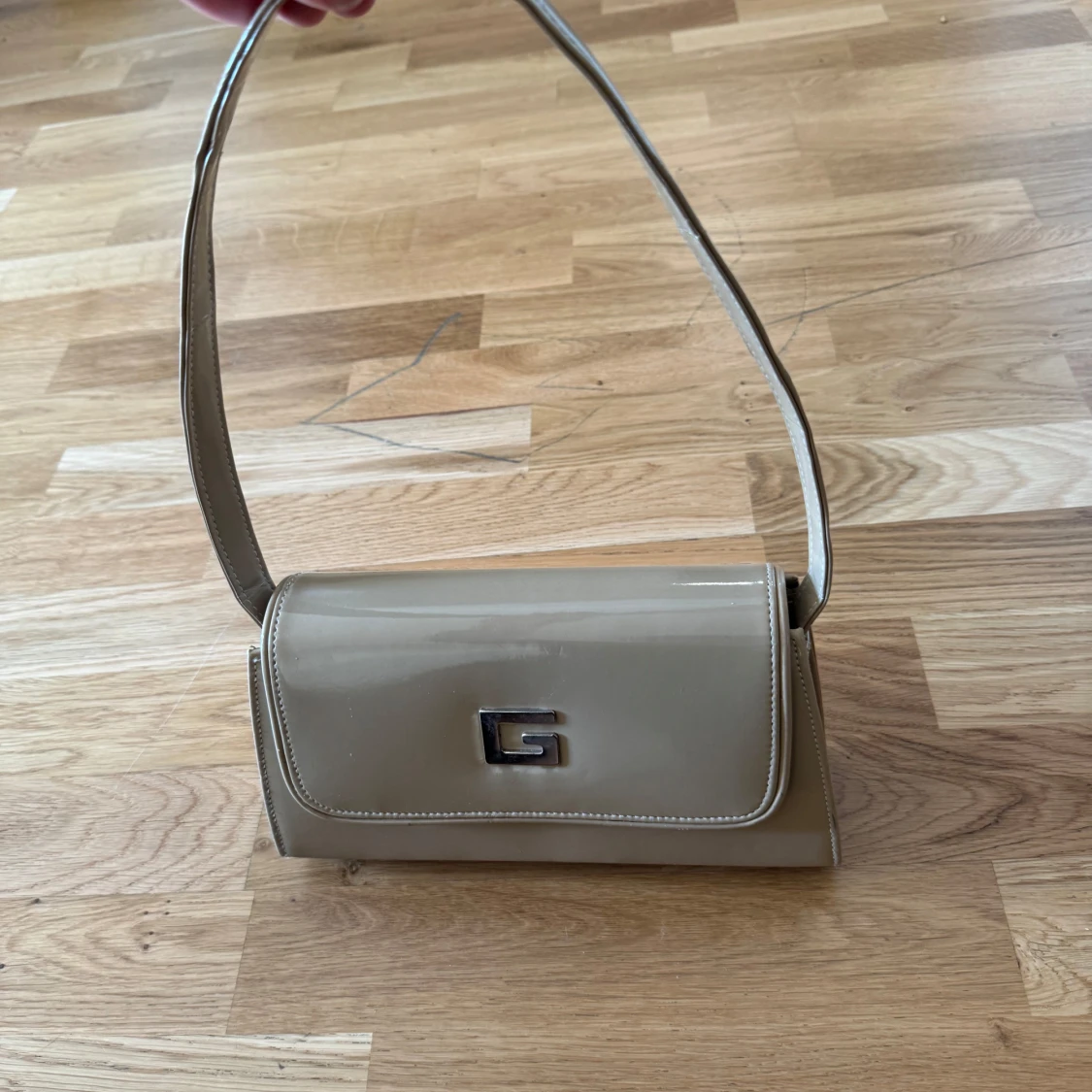 Beige axelväska med metallspänne