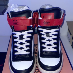 Acne skor - Acne Studios sneakers har en enkel och stilren design med hög kvalitet. Skorna är ofta gjorda av bra material som läder och mocka, vilket gör dem hållbara och snygga. De är lätta att matcha till olika kläder och finns i både klassiska och trendiga mo