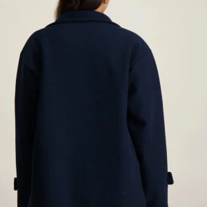 Mörkblå kappa - Snygg marinblå kappa från Ryvls, köpt i kidsbrandstore.Perfekt för kyligare dagar med sin stilrena design och långa ärmar. Passar bra till både jeans och mer uppklädda outfits.Andvänd fåtals ggr , säljer då den inte kommer till användning , nypris 700 kr💫❤️den passar även olika storlekar.Skriv dm för egna bilder samt info❤️