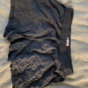 Svarta shorts från ICHI - Säljer ett par svarta shorts från ICHI i storlek M. De har en elastisk midja för extra komfort och är perfekta för en avslappnad stil. Passar bra till sommarens varma dagar. de är jätte mjuka i tyget