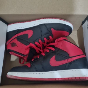 Nike Air Jordans i svart och rött - Säljer ett par snygga Nike Air Jordans i svart och rött. Skorna har en klassisk design med röd snörning och vit sula. Perfekta för både vardag och fest! De är i mycket bra skick och redo för nya äventyr.