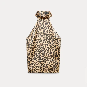 Leopardmönstrad halterneck-topp - Snygg leopardmönstrad halterneck-topp med en stor rosett i ryggen. Perfekt för en utekväll eller fest! Toppen är ärmlös och har en chic och djärv stil som verkligen sticker ut. Pris kan diskuteras och fler bilder om man vill ha det.
