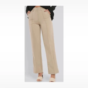 Na-kd kostymbyxor  - Jättefina beigea kostymbyxor från Na-kd. Använda några enstaka gånger. Byxorna har små slitsar på baksidan benen som ni ser på bilderna.🤍 