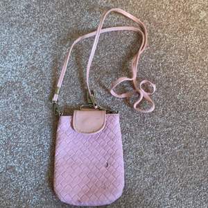 En rosa väska med band perfekt storlek för mobilen! Har dock tre små märken på framsidan och säljs då väldigt billigt! Köpare står för frakt 💗🌺