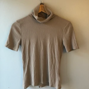 T-shirt/polo - Säljer fin beige topp i väldigt mjukt och bekvämt material. 🧚 Från bikbok! Bara använd en gång.