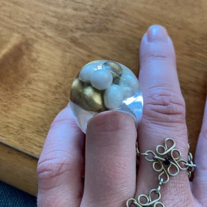 Snygg ring.  - Så snygg ring i plast med vita o guldfärgade pärlor i. Liten storlek. Frakt ingår 