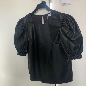 Topp - Så cool och snygg läder topp med lite puffiga ärmar