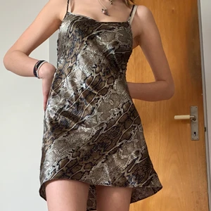 Klänning - Jättefin klänning med ormskinnsmönster. Den är superfin och väldigt bekväm. I sidan har den laceup-detaljer (se bild 3) . Kan passa storlek xs-m beroende på hur man vill att den ska sitta. Klänningen är aningen kort på mig som är 173. köparen står för frakt😘😘