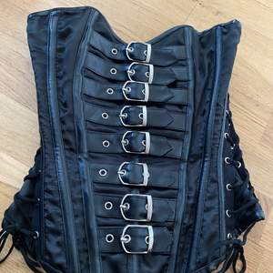 A black corset with pretty details from Burleska. Not used much and in very good condition!
