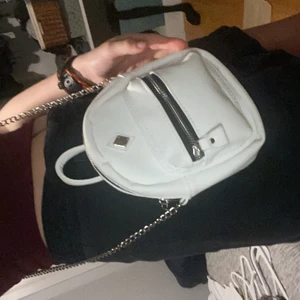 White mini backpack crossbody chain bag - It’s a white soft faux leather like fabric. Good condition. Fits plenty. From the US.