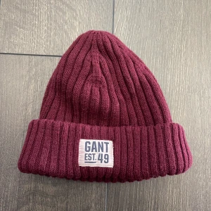 Gant mössa  - Säljer en röd mössa från gant. Den är använd ett fåtal gånger men säljer den då den inte kommer till användning längre🌸 kan mötas upp samt frakta, men då står köparen för frakten😊