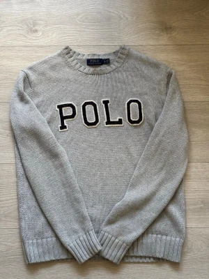Grå stickad tröja från Polo Ralph Lauren - Snygg grå stickad tröja från Polo Ralph Lauren.