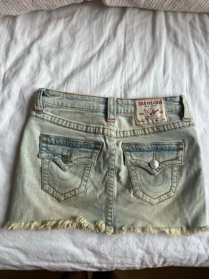 Ljusblå jeanskjol från True Religion - Supersnygg minikjol från true religion. Kjolen är lågmidjad och har små färgade stygn, nypris är 900kr och den har inga som helst defekter❤️🧡💛midjemått rakt över: 34cm          