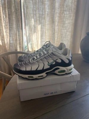 Nike Air Max Plus vita och svarta - Nike Air Max Plus sneakers i vitt och svart med turkos Swoosh och detaljer. Skorna är använt ett fåtal gånger och i mycket bra skick, liten avfärgning på Nike märket bara. 