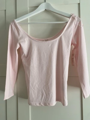Ljusrosa topp från Nelly - Söt ljusrosa topp från Nelly som aldrig är använd med lappen kvar. Däremot har den en liten smink fläck men borde gå bort i tvätten men har inte försökt! Supersöt 