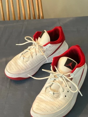 Basketskor Jordan Max Aura 5 Röd och Vit  - Jordan max aura 5 basketskor för barn/unga. Storlek 42 EU. Invändigt mått 26,5 cm. Fungerar utmärkt på både rena och dammiga planer.