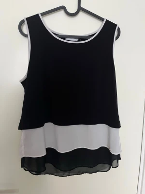 Calvin Klein top - Linne från Calvin Klein. Mesh längst ner men täckande högst upp. Går att styla enkelt, snygg samt luftig nu till sommaren. Den är i storlek M men passar även som S och L beroende på passform.