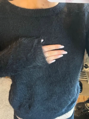 Stickad tröja  - Svart tröja som har ”fluffigt”  lent material. Från vero moda. 