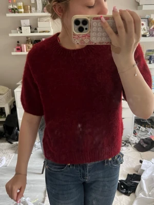 Vinröd stickad tröja Gina Tricot - Mysig vinröd stickad tröja från Gina Tricot med korta ärmar och rund hals. Tröjan har en fluffig, mjuk struktur och är perfekt för lager på lager. Passar till jeans eller kjol för en avslappnad look. sista bilden vart lite suddig❤️