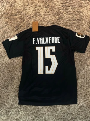 Uruguay vm-bortatröja, F. Valverde - Uruguays bortatröja i vm från Nike med nr 15, och F. Valverde på ryggen. Tröjan är i storlek M med vm-loggorna på axlarna 