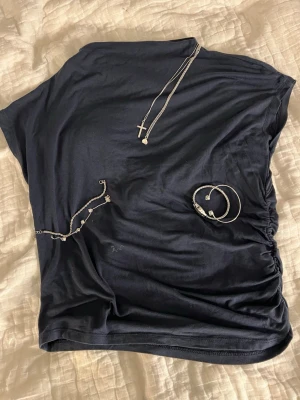 Mörkblå omlott topp med rynk - Snygg mörkblå topp som är scrunchad på ena sidan. 