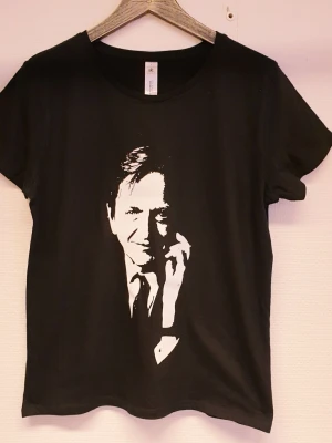 Olof Palme Svart t-shirt - Svart t-shirt från B&C Collection med ett stort vitt PALME framtill. Klassisk rund halsringning och korta ärmar. Tillverkad i mjuk bomull som känns skön mot huden. Storlek Large (dam)