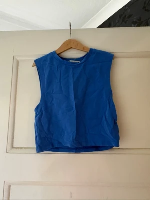 Blå ärmlös magtröja från Zara 🩷🫰🏻 - Snygg blå ärmlös topp från Zara med rund halsringning. Tillverkad i mjuk bomull, perfekt för varma dagar. Enkel och stilren design som är lätt att matcha med olika outfits. 