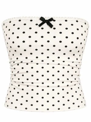 Prickig vit tubtopp med rosett  - Söt vit tubtopp med svarta prickar och en liten svart rosett upptill. Toppen är axelbandslös och har en smickrande bandeauform. Perfekt för varma dagar och enkel att styla med jeans eller kjol.