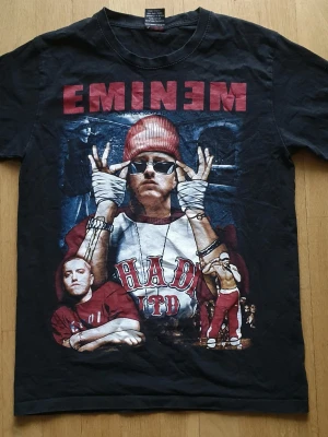 Eminem T-Shirt | M / Medium | Retro Y2K - T-Shirt med Eminem tryck på framsidan i härlig 90/00-tals stil!  Rock@Tees Medium (Mått finns på bilderna!) 100% bomull.  Se bilder.  Kika in mina andra annonser!
